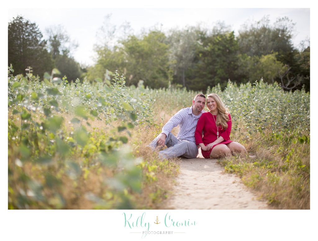 A couple sit on a path  | Kelly Cronin Photography | Outdoor Engagement Session