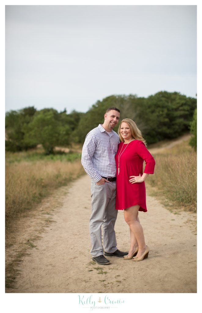 A couple stand on a path  | Kelly Cronin Photography | Outdoor Engagement Session
