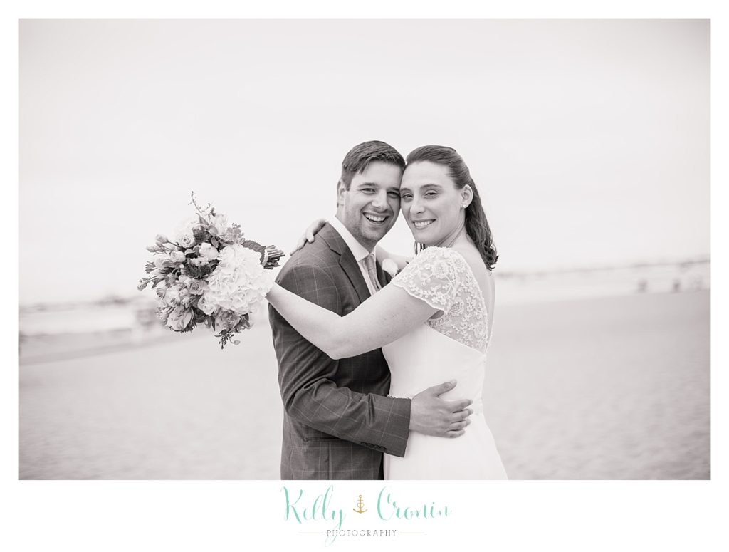 A bride hugs her groom | Kelly Cronin Photography | Pilgrim Monument