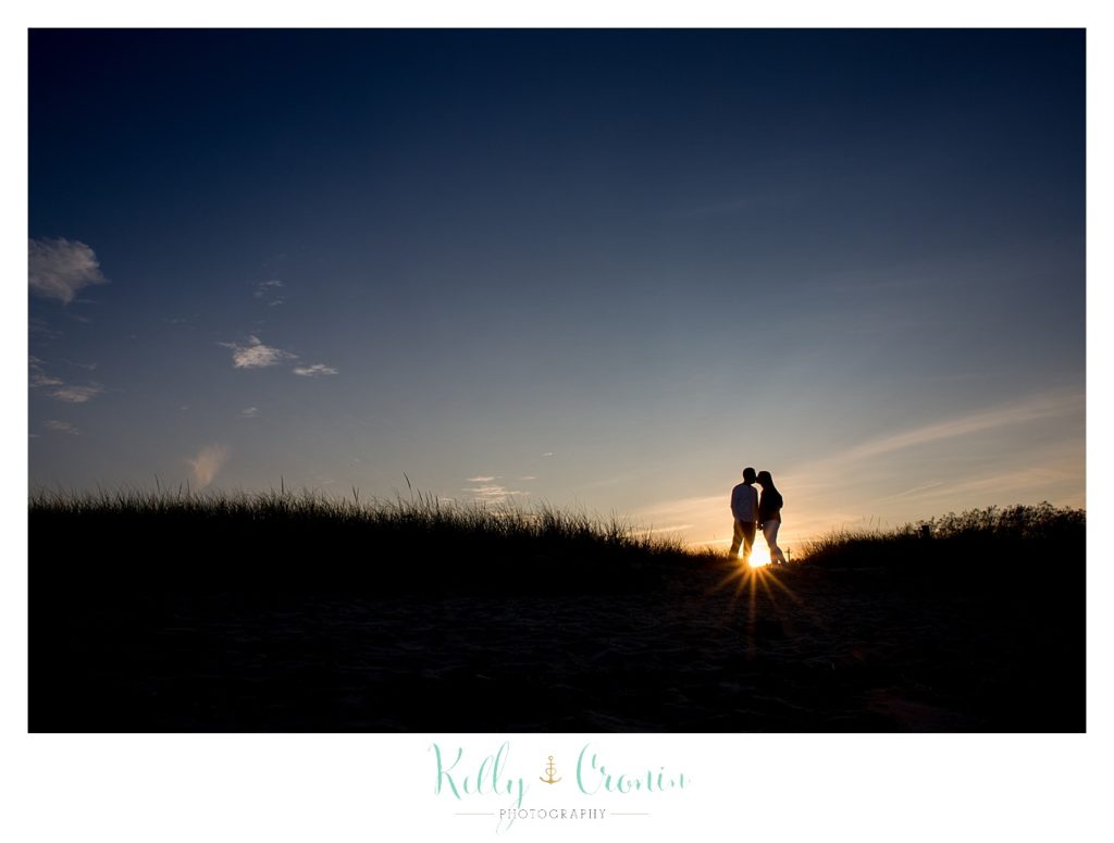 A couple kiss at sunset | Kelly Cronin Photography | Cape Cod Engagement Photographer