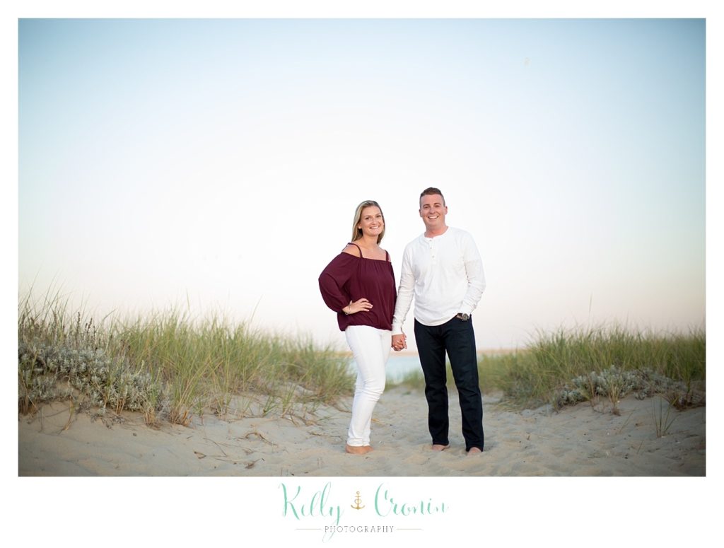 A couple stand on the beach | Kelly Cronin Photography | Cape Cod Engagement Photographer