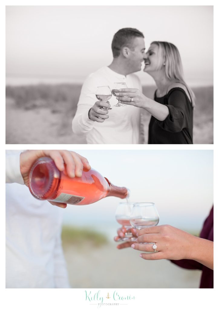 A couple drink champagne | Kelly Cronin Photography | Cape Cod Engagement Photographer