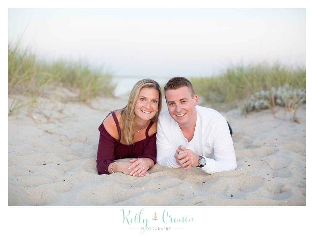 A couple lay on the stomachs | Kelly Cronin Photography | Cape Cod Engagement Photographer
