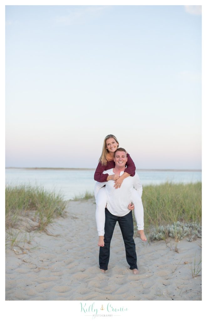 A man gives his love a ride | Kelly Cronin Photography | Cape Cod Engagement Photographer