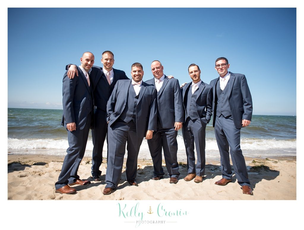 A groom poses with his groomsmen | Kelly Cronin Photography | Resort Wedding in Cape Cod