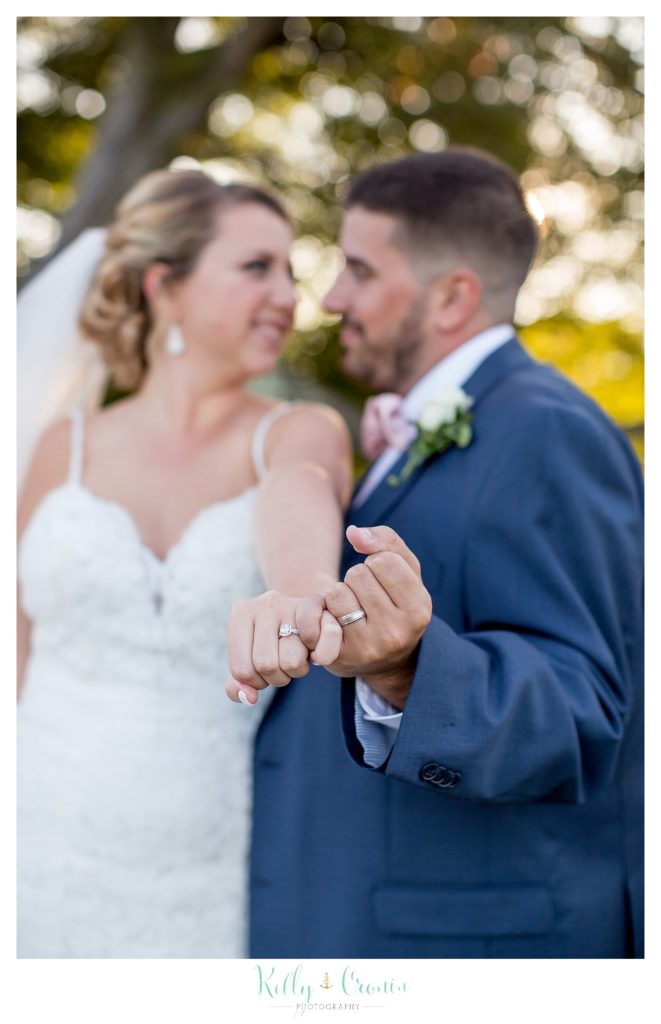 A groom and bride pinky swear | Kelly Cronin Photography | Resort Wedding in Cape Cod