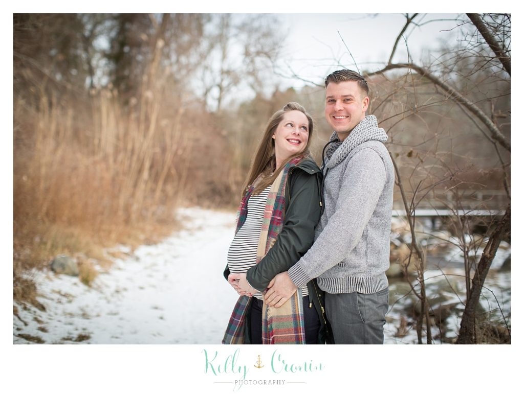 A man hugs his pregnant wife | Kelly Cronin Photography | Cape Cod Maternity Photographer