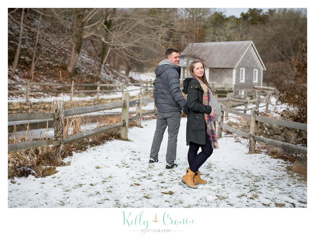 A couple stand in snow  | Kelly Cronin Photography | Cape Cod Maternity Photographer