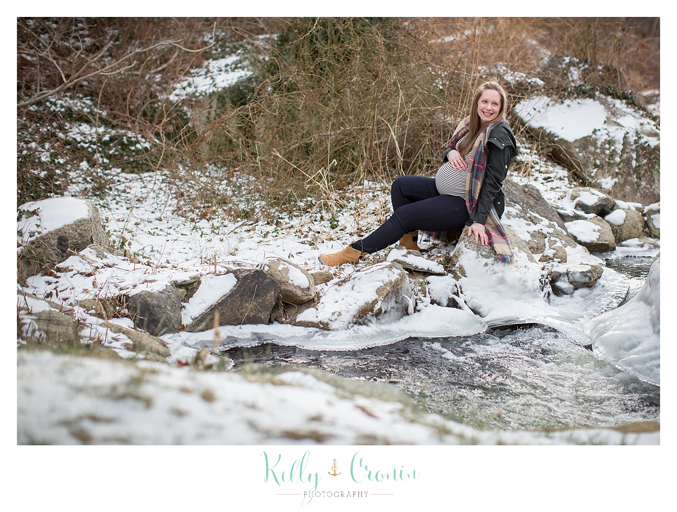 A pregnant woman lays in the snow | Kelly Cronin Photography | Cape Cod Maternity Photographer