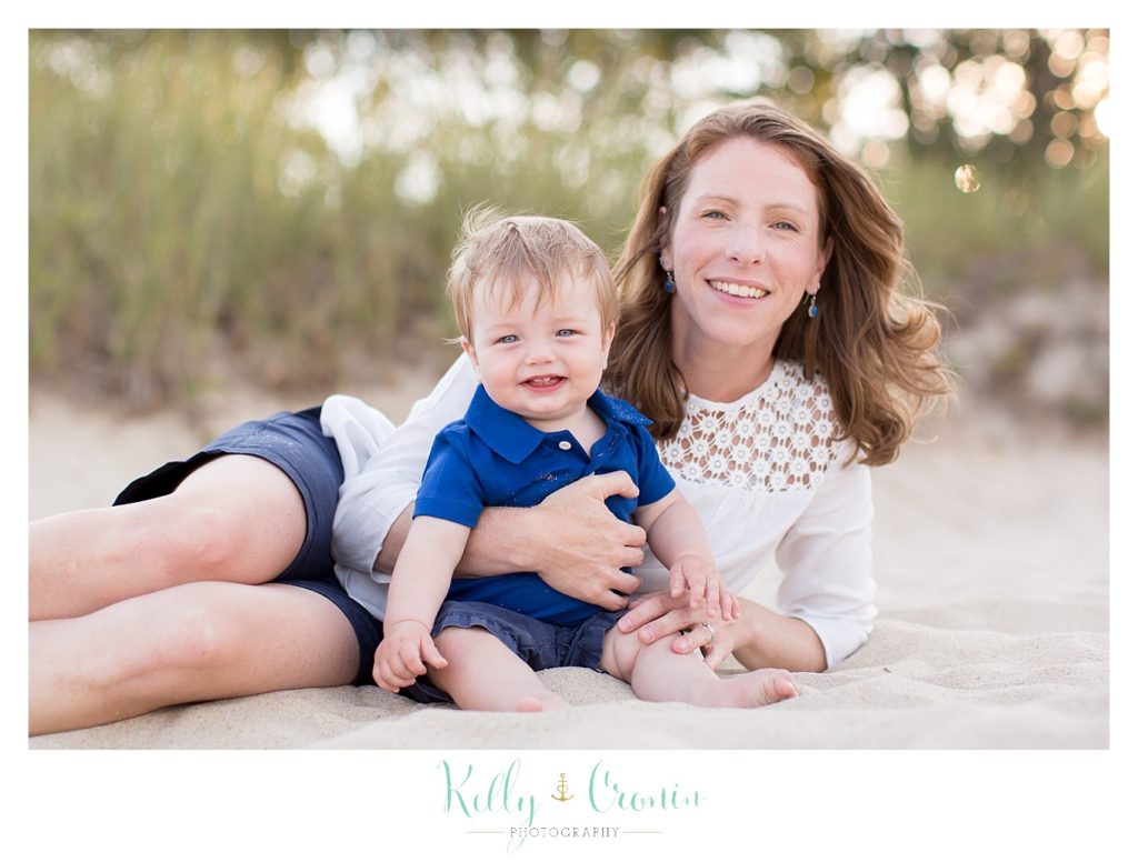 A mother sits with her baby  | Kelly Cronin Photography | Seaside Photography