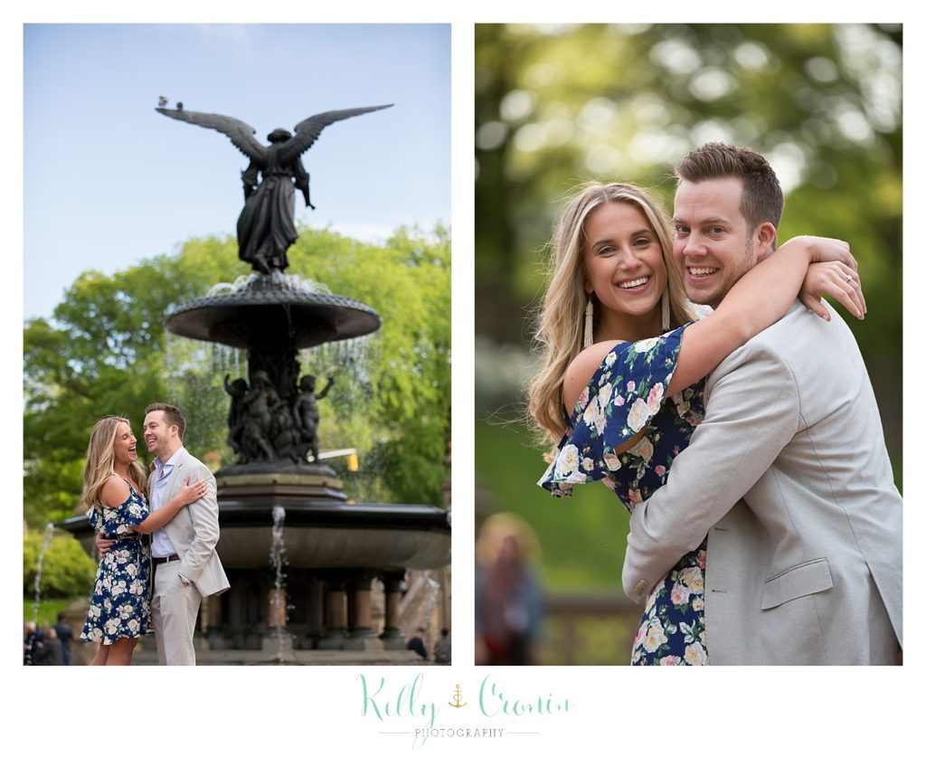 A couple hug in front of a fountain  | Kelly Cronin Photography | NYC Engagement Shoot