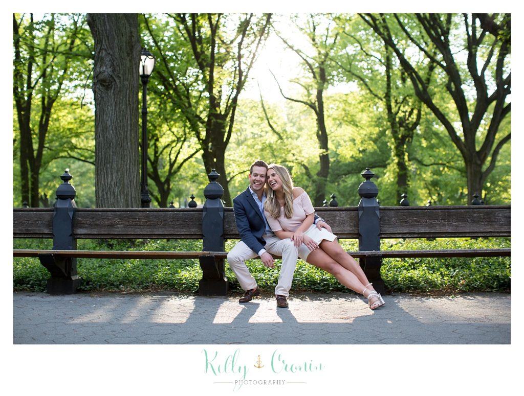 A couple hang out on a park bench  | Kelly Cronin Photography | NYC Engagement Shoot