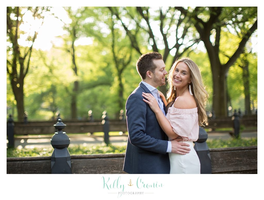 A man holds his fiance close  | Kelly Cronin Photography | NYC Engagement Shoot