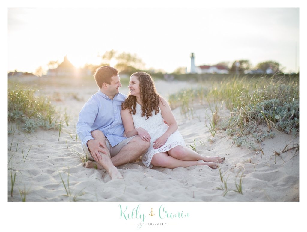 A woman looks at her fiance, captured by a Cape Cod engagement photographer. 