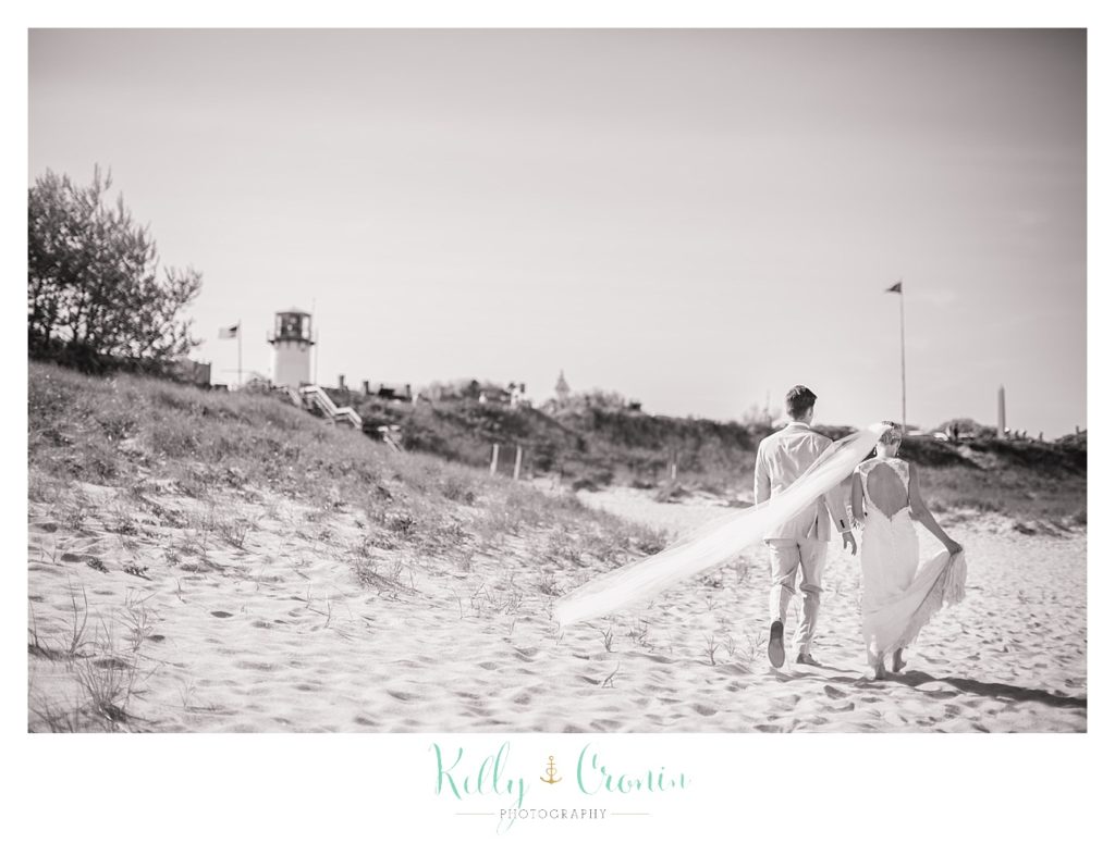 A man walks with his bride, captured by a Cape Cod wedding photographer. 