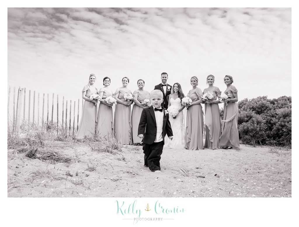 A boy stands in front of a bridal party | Kelly Cronin Photography | Cape Cod love story