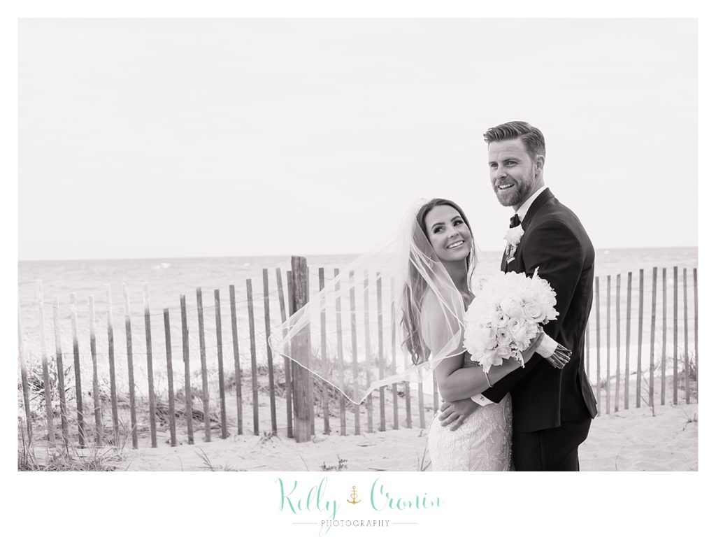 A couple hug each other on their wedding day | Kelly Cronin Photography | Cape Cod love story