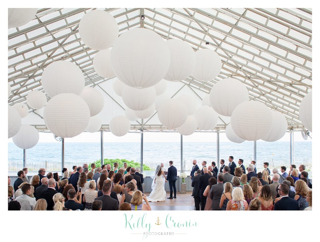 A venue is decorated in white for a wedding reception | Kelly Cronin Photography | Cape Cod love story