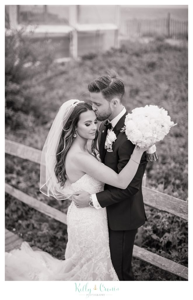 A woman hugs her new husband | Kelly Cronin Photography | Cape Cod love story