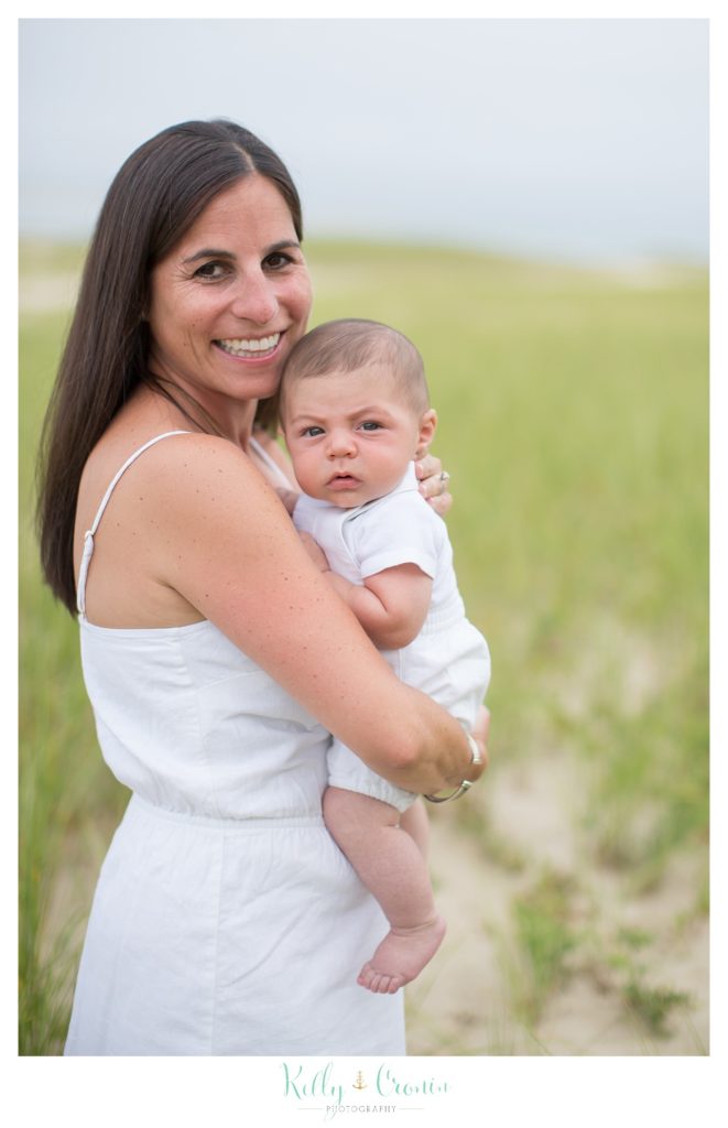 A mother holds her baby boy  | Kelly Cronin Photography | Seaside Session in Cape Cod