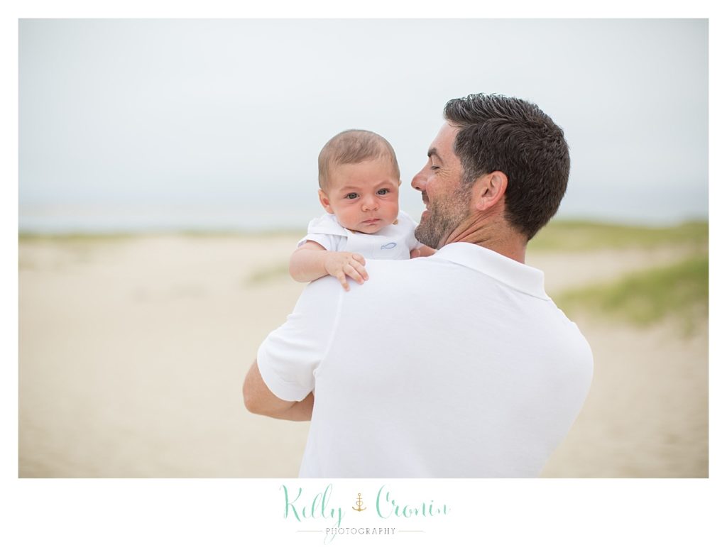 A man holds his son  | Kelly Cronin Photography | Seaside Session in Cape Cod