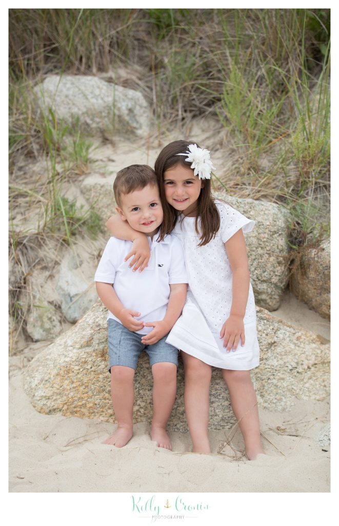A girl hugs her brother  | Kelly Cronin Photography | Seaside Session in Cape Cod
