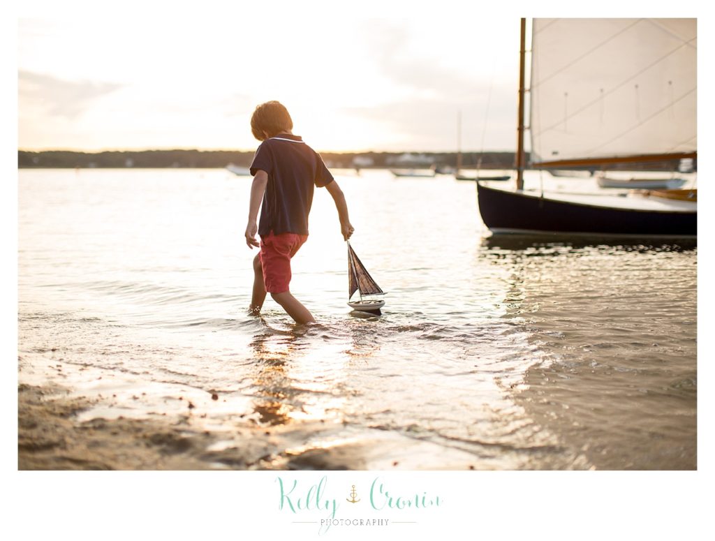 A Cape Cod family photographer captures a boy playing in the water. 
