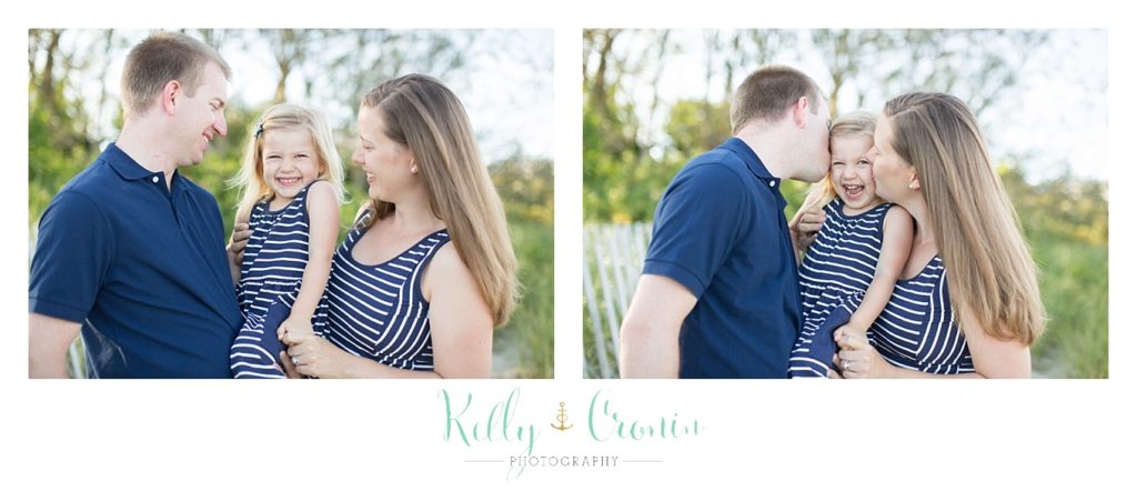 A couple kiss their little girl | Kelly Cronin Photography | Family Photography in Cape Cod