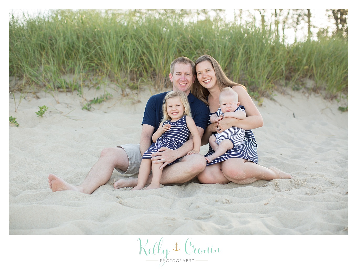 A family sits in the sand | Kelly Cronin Photography | Family Photography in Cape Cod
