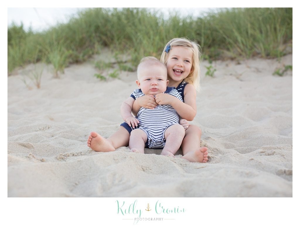 A little girl holds her baby brother | Kelly Cronin Photography | Family Photography in Cape Cod