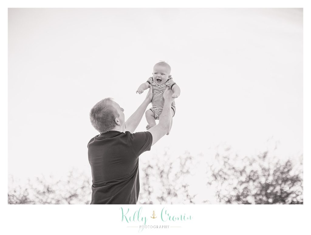 A man plays with his baby | Kelly Cronin Photography | Family Photography in Cape Cod