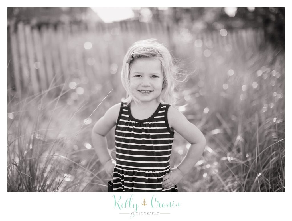 A little girl puts her hands on her hips | Kelly Cronin Photography | Family Photography in Cape Cod