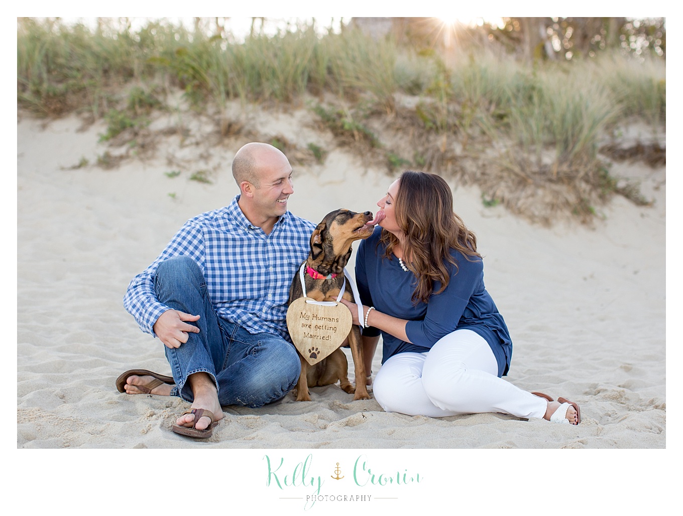 An engaged couple enjoy some puppy love on the Cape with their dog.