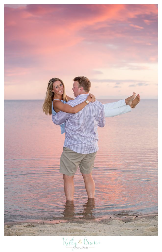 A man holds his fiance on Hardings Beach