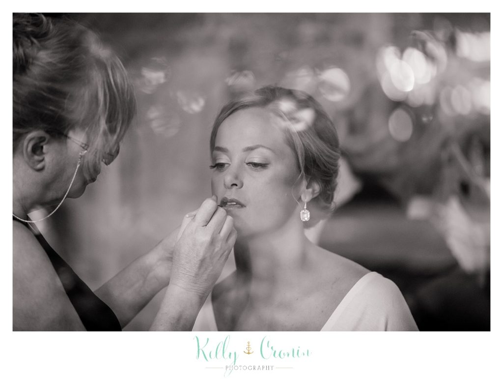 A brides make-up is applied in preparation for her wedding at Wequassett Resort and Golf Club. 