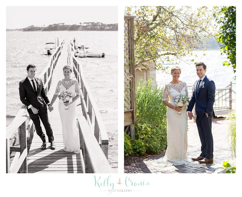 A couple walk on a dock. 