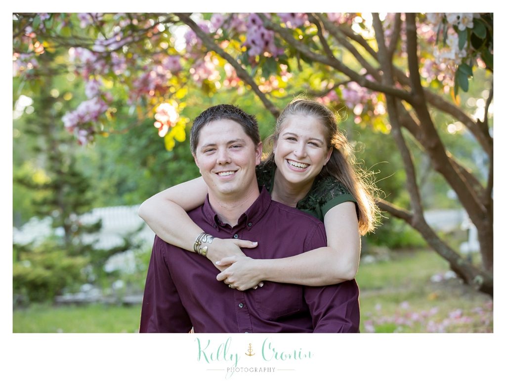 A woman hugs her fiance from behind | Family Photographer In Cape Cod 