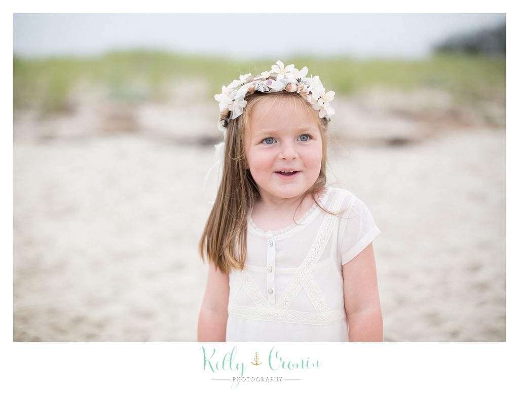 A little girl is wearing a flower crown on the beach | Family Photographer In The Cape