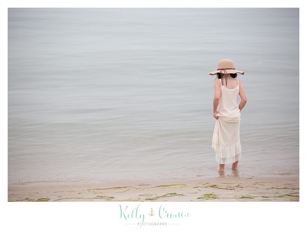 A little girl dips her toes in the ocean | Family Photographer In The Cape