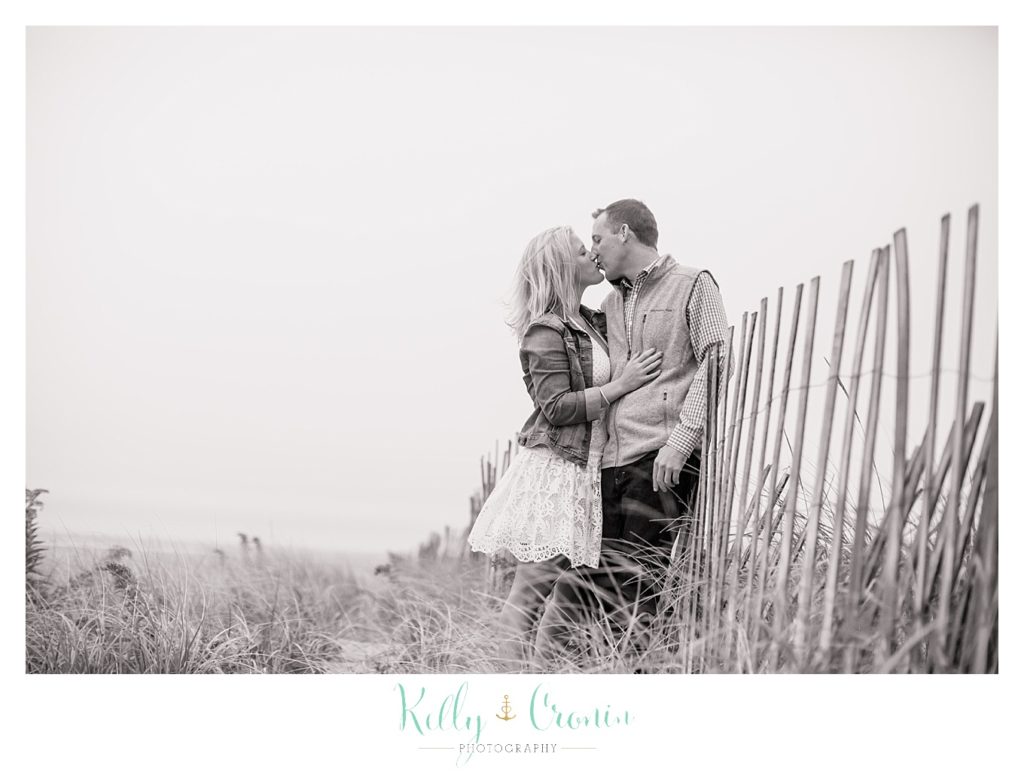 A woman kisses her fiance | Cape Cod Engagement Photographer 