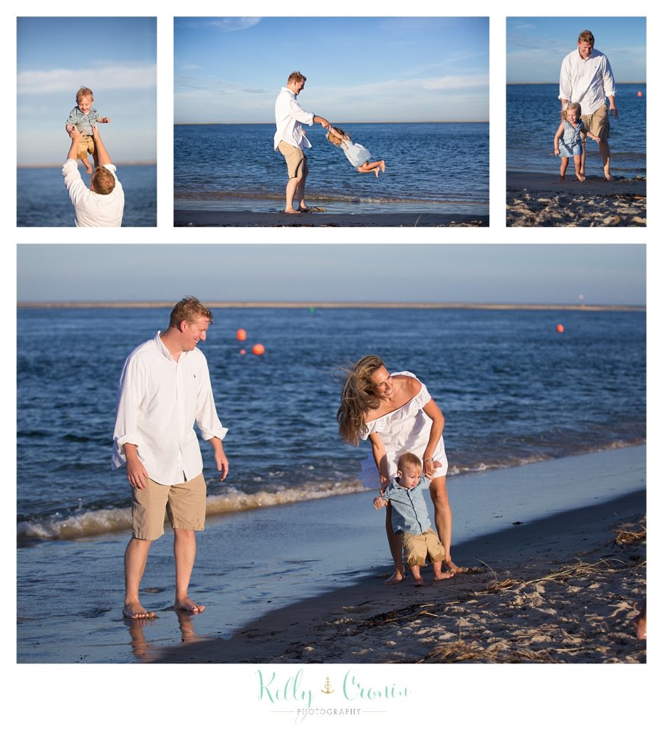 A family plays together in the water on a beautiful beach. 