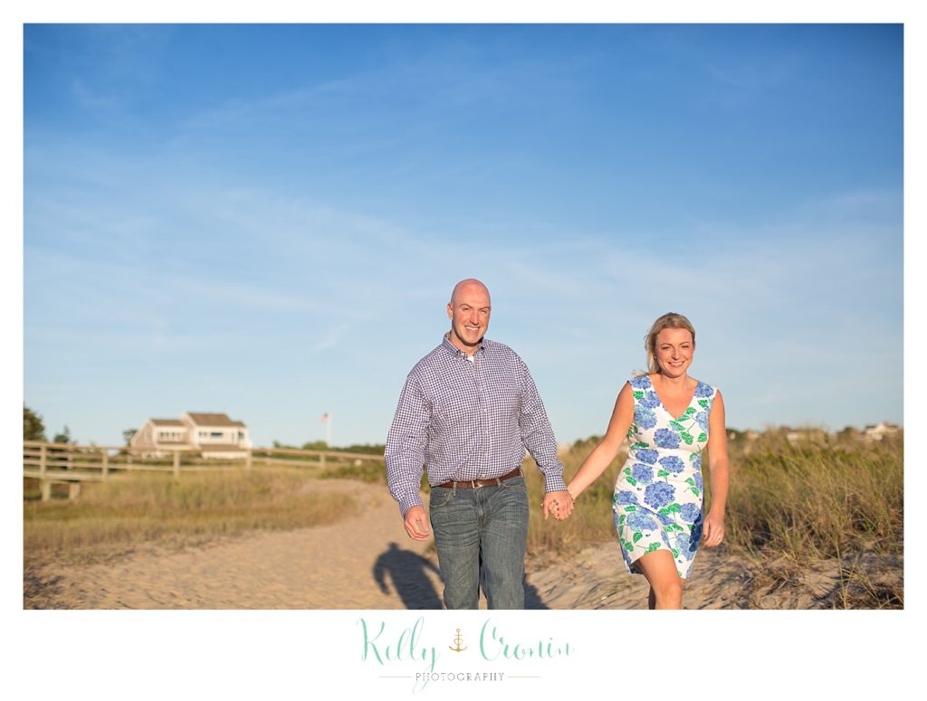 A couple walk on the beach together | Engagement Session In Cape Cod