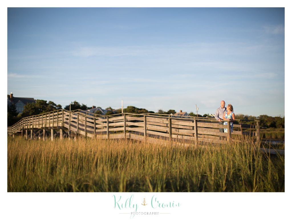 A couple walk on a pier | Engagement Session In Cape Cod