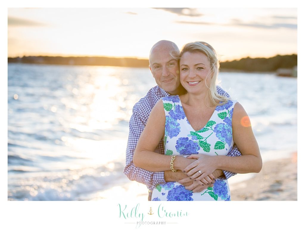 A man hugs his fiance from behind | Engagement Session In Cape Cod
