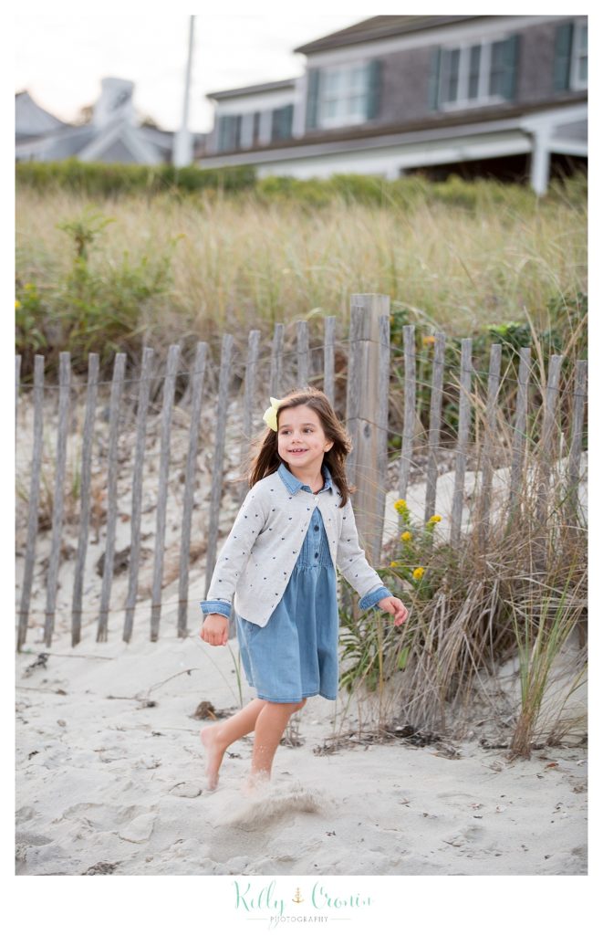 A girl runs on the beach. 