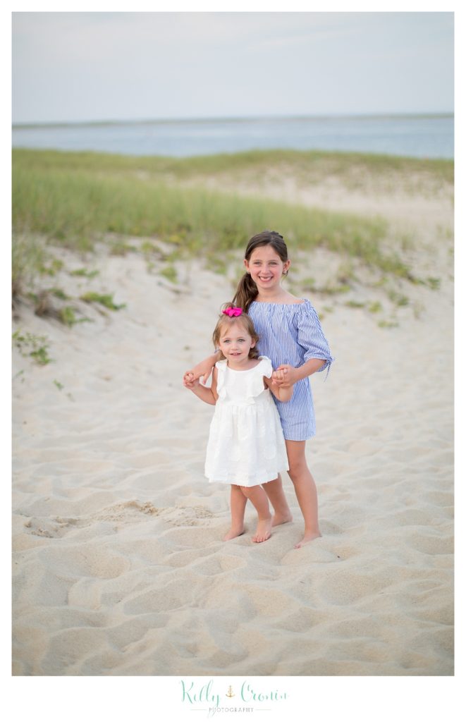 Two small girls pose for their Outdoor Family Photos. 