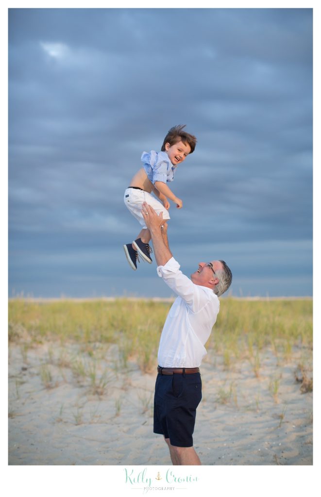 A man throws his son into the air.
