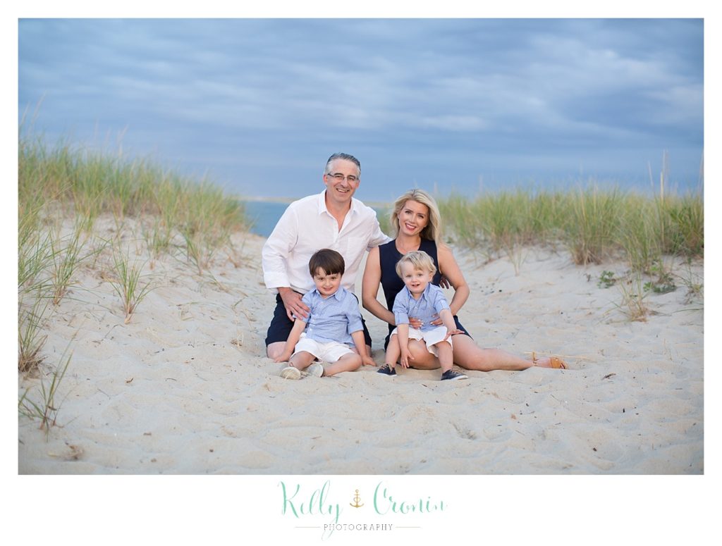 A family sits for their family portraits in Cape Cod. 