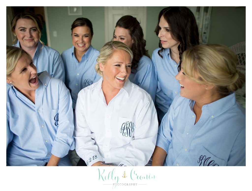 A bride chats with her bridal party while they get ready. 