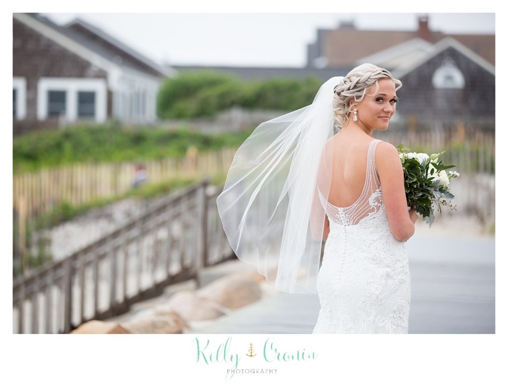 A bride shows off her dress at her Bourne Farm Wedding. 